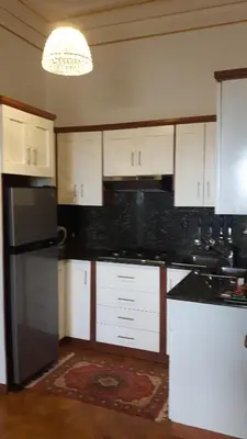 a kitchen with white cabinets and black counter tops at Villa Florencia in Boca Chica
