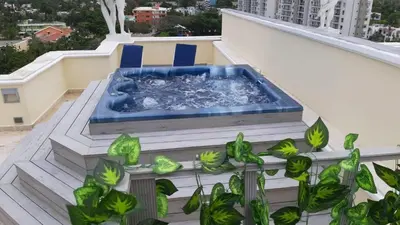 a hot tub on the roof of a building with plants at Villa Florencia in Boca Chica