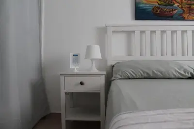 a bedroom with a bed and a lamp on a nightstand at B&B Villa Luna in Bayahibe