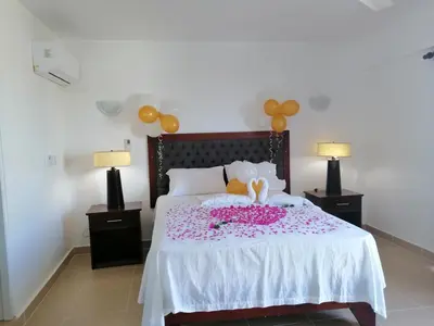 a bed with two stuffed animals on top of it at La Ensenada Boutique Hotel in Punta Rucia