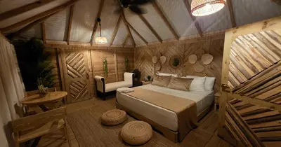 a bedroom with a bed and a table in a room at Glamping EcoLodge Cueva De Las Aguilas in Pedernales