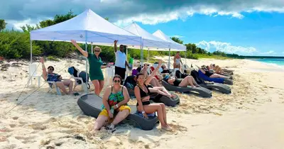 a group of people sitting on the beach at Glamping EcoLodge Cueva De Las Aguilas in Pedernales