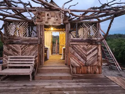 an open door to a wooden house with a ladder at Glamping EcoLodge Cueva De Las Aguilas in Pedernales