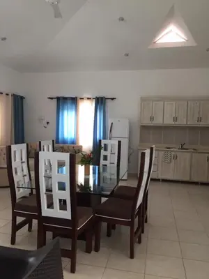 a dining room with a glass table and chairs at Villas Michaela Caribbean in Sosúa