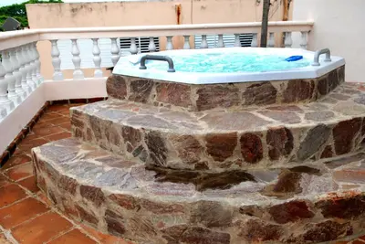 a hot tub sitting on top of a brick patio at Hotel Maison Gautreaux in Santo Domingo