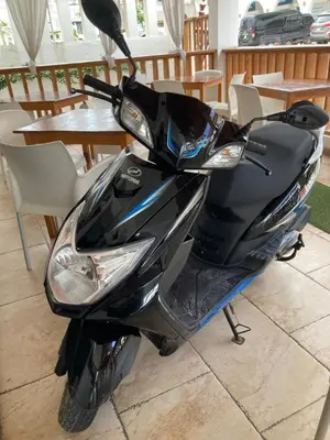 a motor scooter parked in front of a table at Casita Blanca Bayahibe in Bayahibe