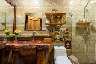 a bathroom with a wooden sink and a toilet at Vista de Águilas Ecolodge in Pedernales