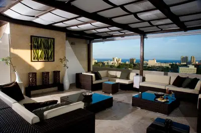 a living room with couches and a view of the city at Barceló Santo Domingo in Santo Domingo