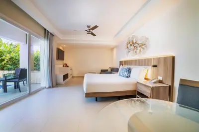a bedroom with a bed and a living room at Royalton Hideaway Punta Cana, An Autograph Collection All-Inclusive Resort & Casino - Adults Only in Punta Cana
