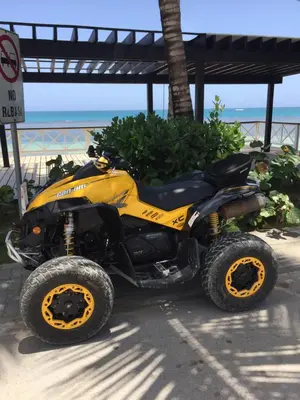 a yellow atv parked next to the beach at Aligio Beachfront Paradise in Las Terrenas