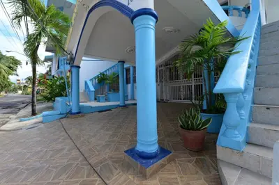 a blue water slide in a building with palm trees at Villa Antonia 16 in Sosúa