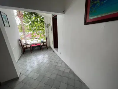a hallway with two chairs and a table and a window at Villa Antonia 16 in Sosúa