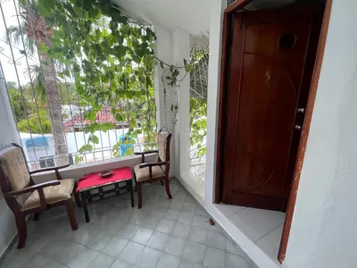 a room with a table and chairs and a window at Villa Antonia 16 in Sosúa