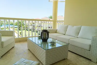 a living room with a couch and a table at 3BR / 3BA Modern Paradise Loft Condo in Gated Community w/ Daily Housekeeping in Sosúa