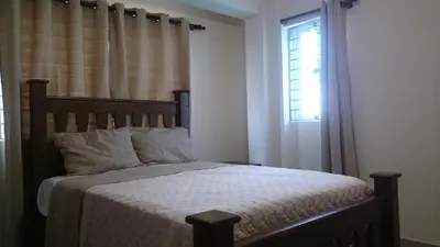 a bedroom with a bed and a window at Luxury Karla Apartments in Las Flores