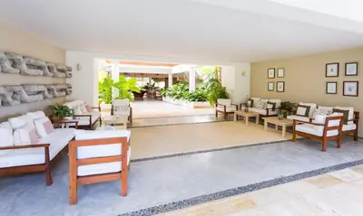 a living room with a lot of chairs and tables at Apartment in Sublime Samana Résidence in Las Terrenas