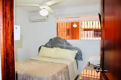 a bedroom with a bed and a window at Apartamento Los Rieles in Santiago de los Caballeros