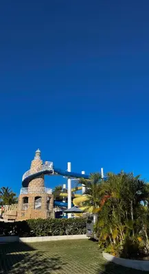 a view of a resort with palm trees and a building at 2BR 2BA Beachfront With View 71 in Bayahibe