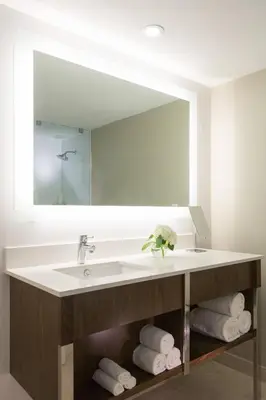 a bathroom with a sink and a large mirror at Renaissance Santo Domingo Jaragua Hotel & Casino in Santo Domingo