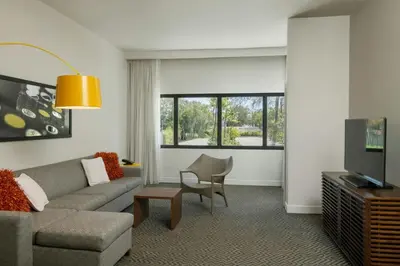 a living room with a couch and a tv at Renaissance Santo Domingo Jaragua Hotel & Casino in Santo Domingo