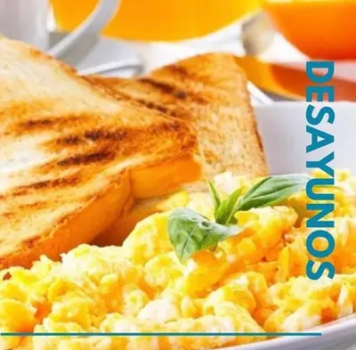a plate of scrambled eggs and toast with bread at Caribbean Hotel Santo Domingo in Santo Domingo