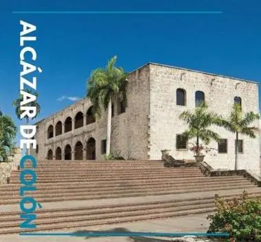 a building with stairs and palm trees in front of it at Caribbean Hotel Santo Domingo in Santo Domingo