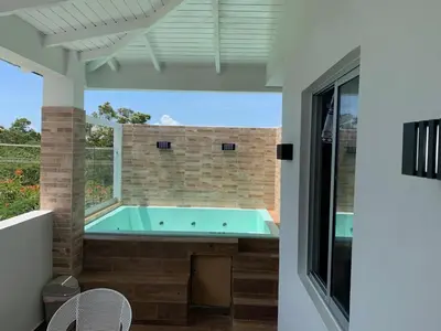 a hot tub on the patio of a house at KSL Residence in Boca Chica