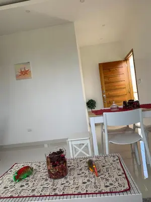 two birds sitting on a table in a room at KSL Residence in Boca Chica