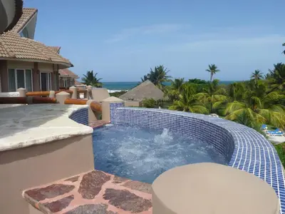 a swimming pool on the side of a house at Luxury apartment with ocean view at the beach in Cabarete