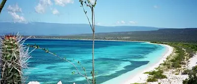 a beach with turquoise water and white sand at Hotel Pedernales Italia Republica Dominicana in Pedernales