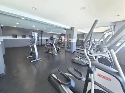 a gym with several rows of cardio machines at Las Olas by Destinos1a in Juan Dolio