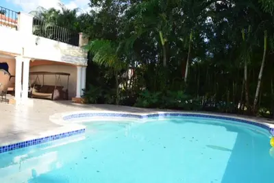 a large swimming pool in front of a house at Villa M-6 Metro Country Club in Juan Dolio