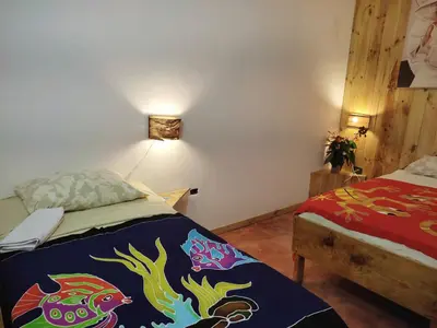 a bedroom with a bed with a colorful blanket at Hostel La Ballena Backpacker in Las Galeras