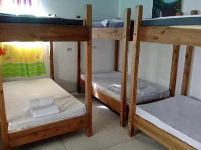 a group of bunk beds in a room at Hostel Quintonido in Jarabacoa