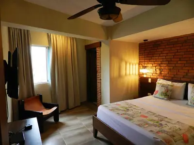 a bedroom with a bed and a ceiling fan at MON Hotel Boutique in Constanza
