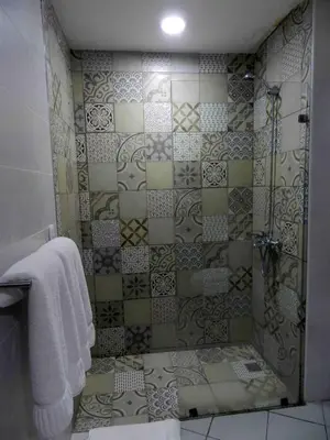 a bathroom with a shower with a glass door at MON Hotel Boutique in Constanza