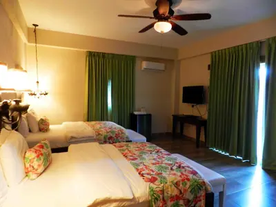 a bedroom with a bed and a ceiling fan at MON Hotel Boutique in Constanza