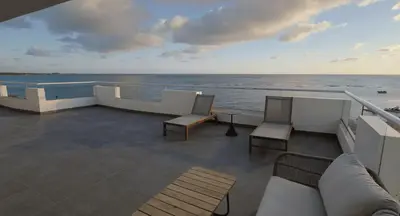 a balcony with chairs and a view of the ocean at Santo Domingo Bay Convention Resort & Casino in Boca Chica