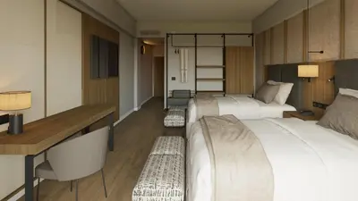 a hotel room with two beds and a desk at Santo Domingo Bay Convention Resort & Casino in Boca Chica