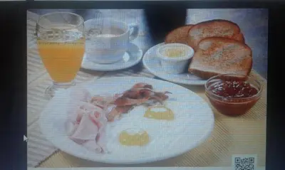 a table with a plate of breakfast food and drinks at Ecotopía Park in El Hoyo del Cacao
