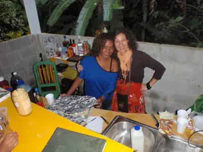 two women standing in a kitchen with a sink at Ecotopía Park in El Hoyo del Cacao