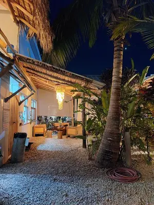 a resort with a palm tree and a building at Residencia El Balatà in Las Terrenas
