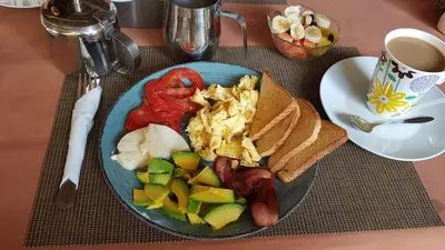 a blue plate of food with a sandwich and vegetables at Residencia El Balatà in Las Terrenas