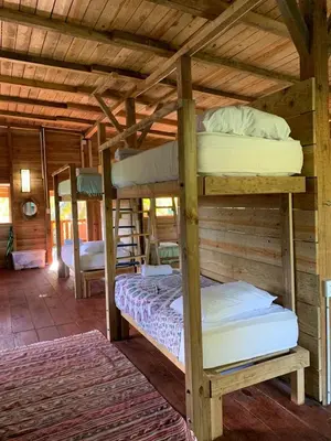 a bedroom with two bunk beds in a cabin at Aventura Rincon Ecolodge in Las Galeras