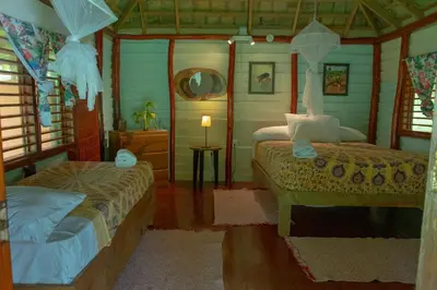 a bedroom with two beds in a house at Aventura Rincon Ecolodge in Las Galeras