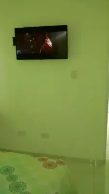 a flat screen tv hanging on a wall at Casa Vasquez in San Felipe de Puerto Plata