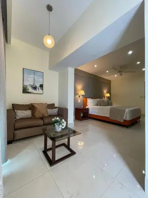 a living room with a bed and a couch at Nilka Hotel Boutique in Santa Bárbara de Samaná