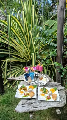 a picnic table with plates of food on it at Casa Picaflor B&B in Las Terrenas