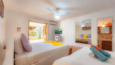a bedroom with a large bed and a window at Paradiso del Caribe in Las Galeras