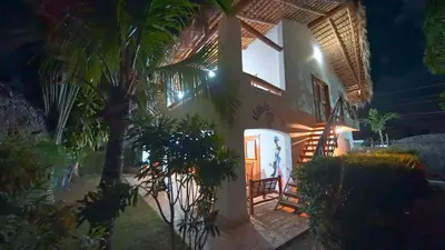 a house with a palm tree in front of it at Paradiso del Caribe in Las Galeras